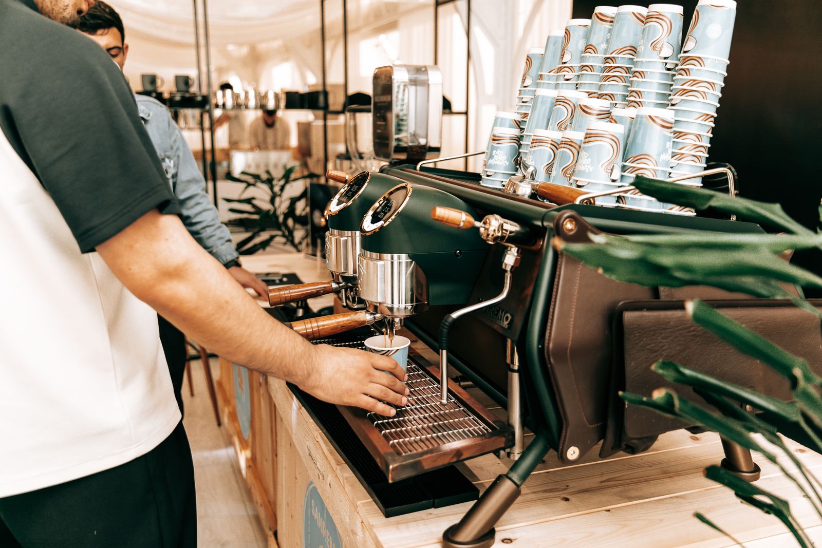 A barista making espresso for event guests