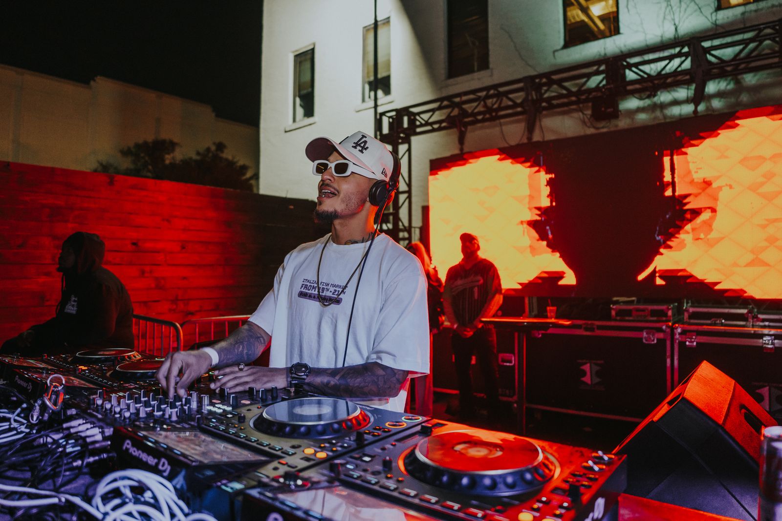A DJ mixing music at a wedding reception