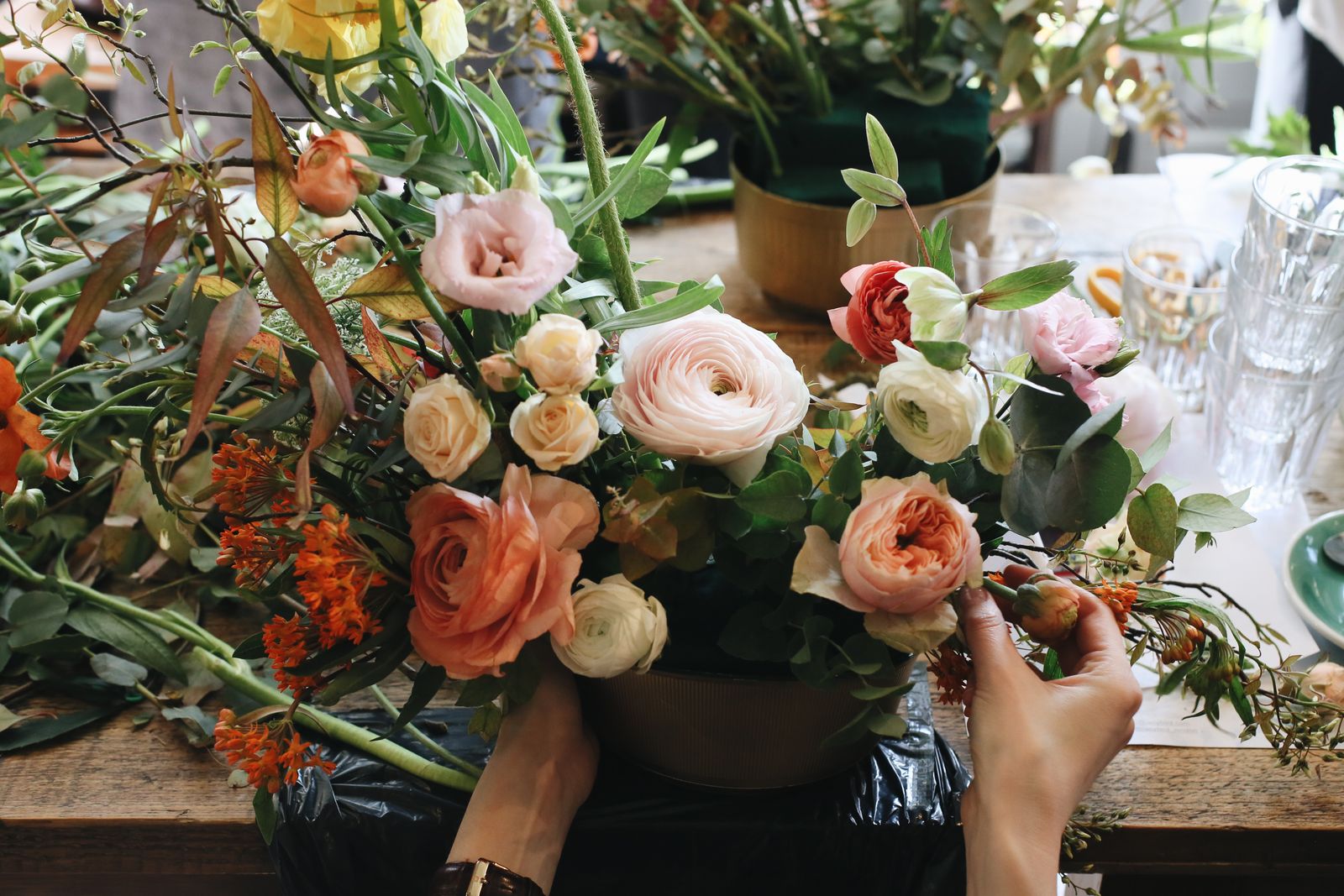 A florist arranging a fresh flower bouquet by hand