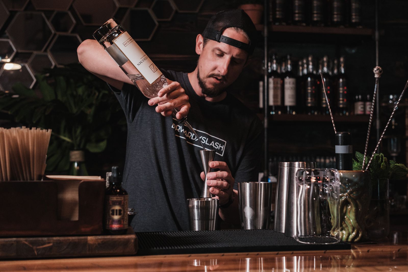A bartender preparing a cocktail at an event bar
