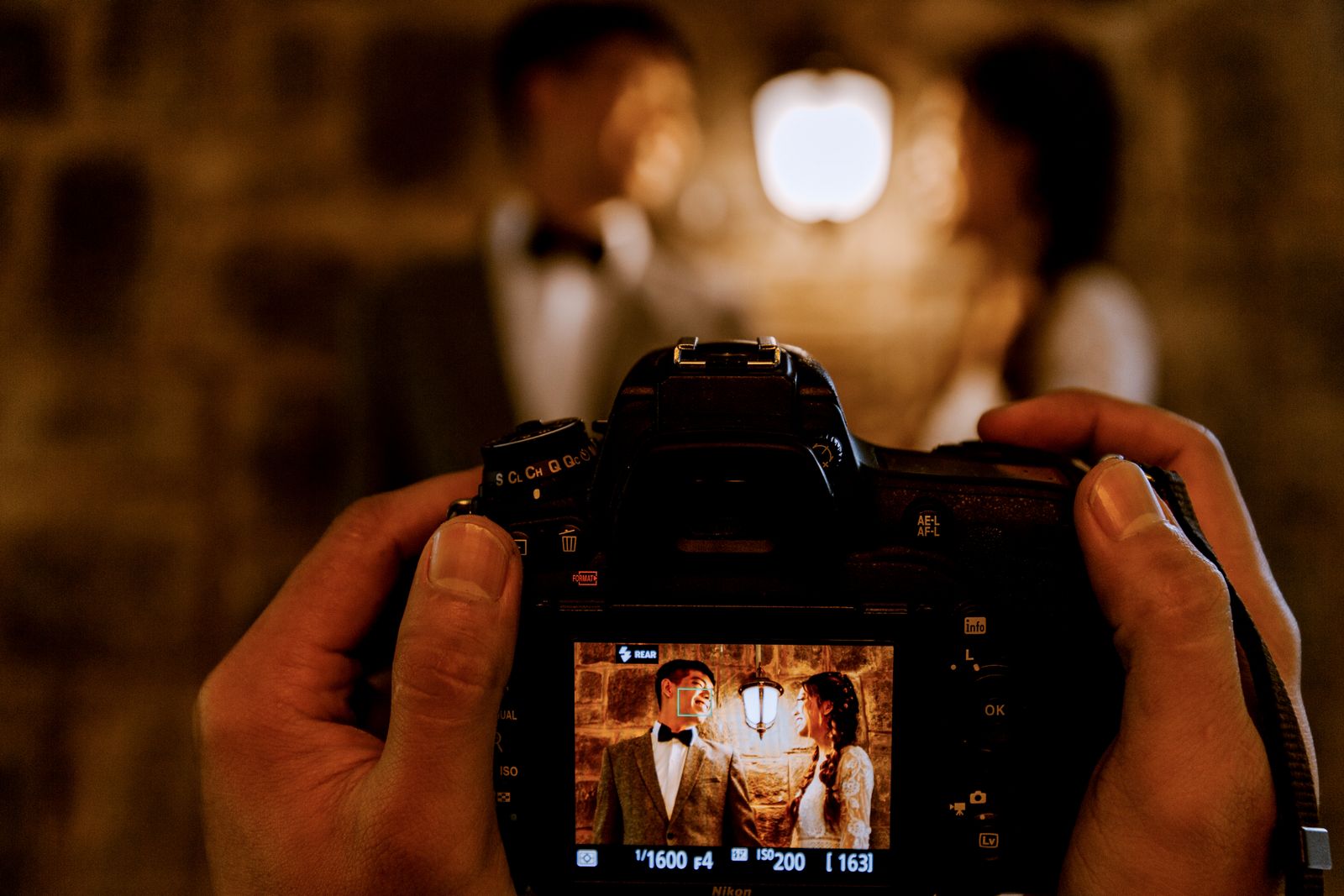 A wedding photographer capturing a couple with a professional camera